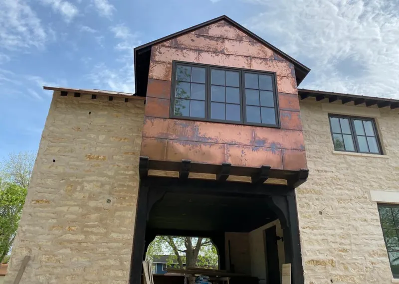 Copper metal panel facade on a stone building for Skylight Installation in Spanish Lake